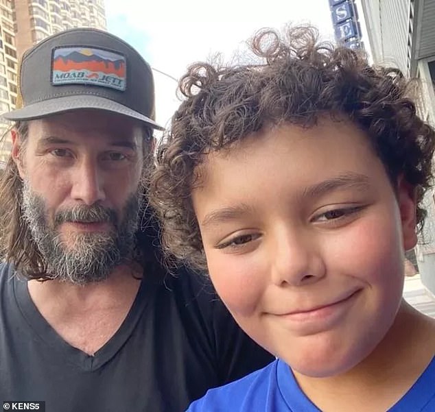 Keanu Reeves plays catch with a nine-year-old child before heading to Houston to perform with his band Dogstar.